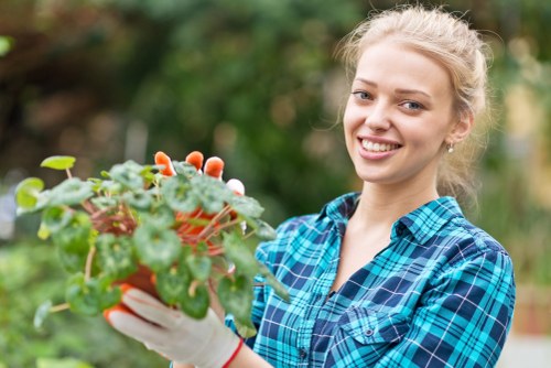 Gardener inspecting a garden with tools, close-up